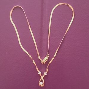 14k gold vintage pendant/necklace with 6 melee diamonds & one solitaire diamond.